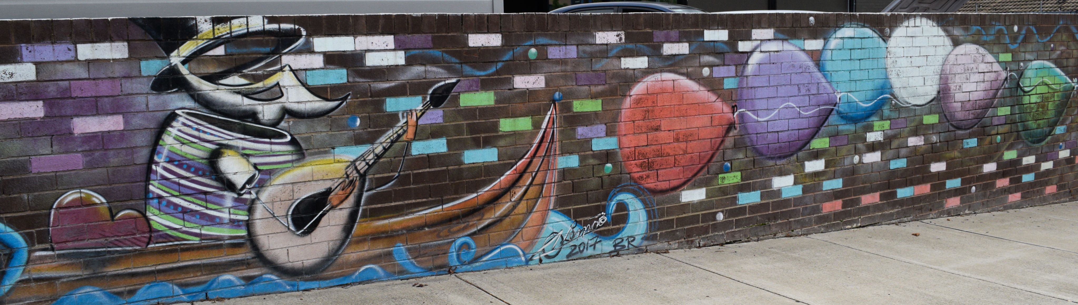 Colourful Graffiti, creature playing banjo in canoe 