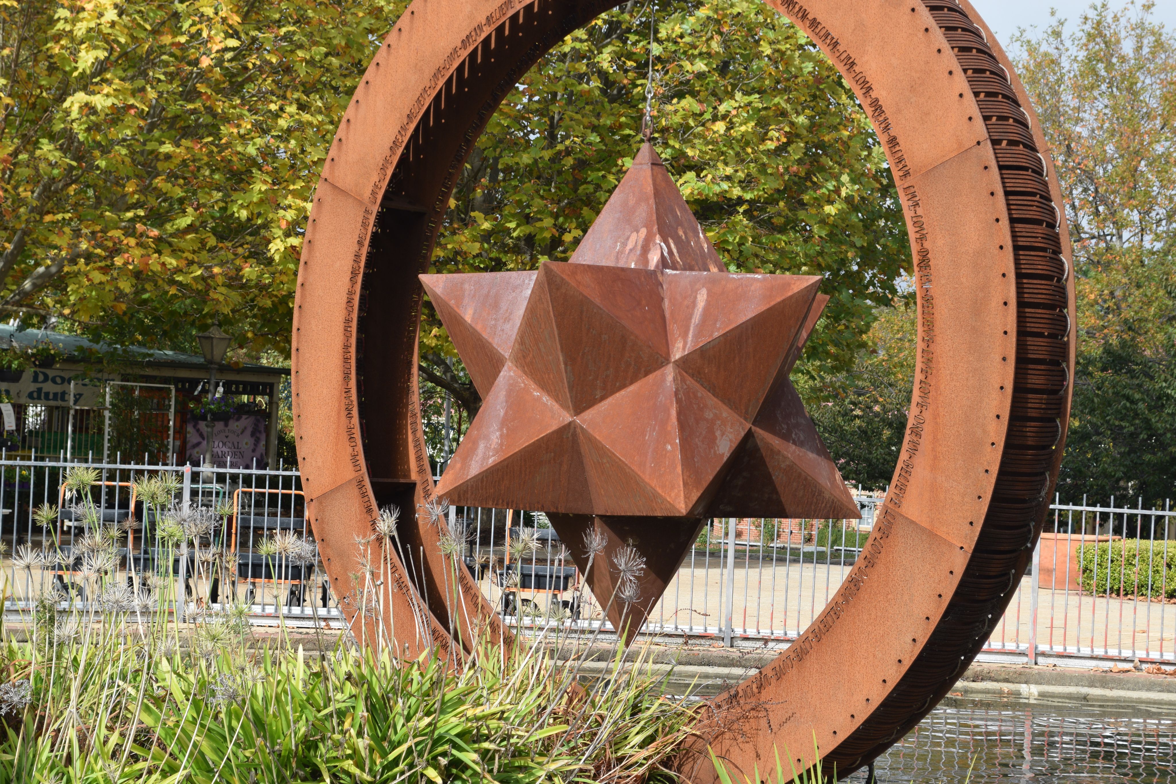 Large metal star hanging in a sphere.