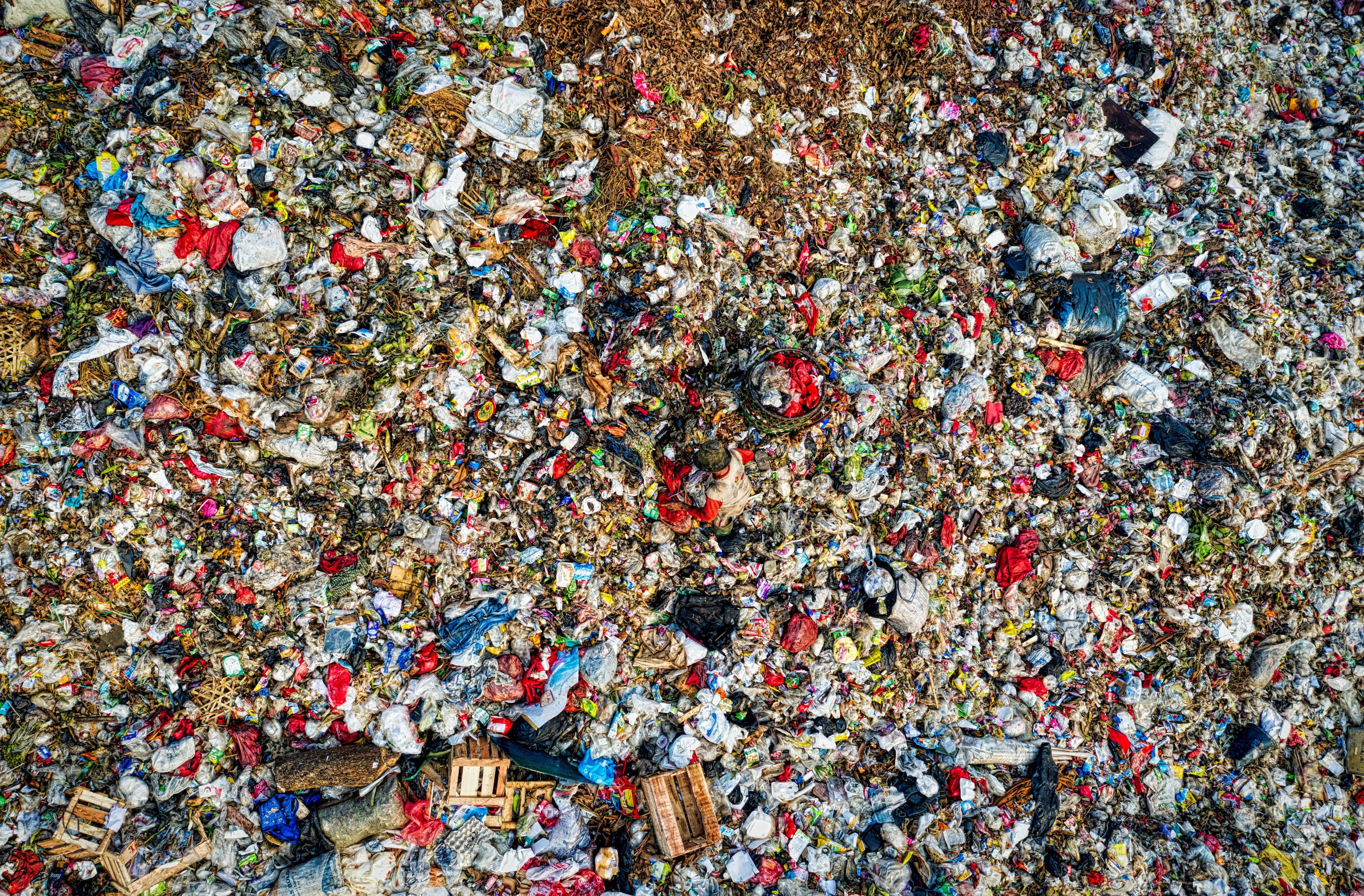 An aerial photograph of landfill with so much waste that each individual item is almost unrecognizable.