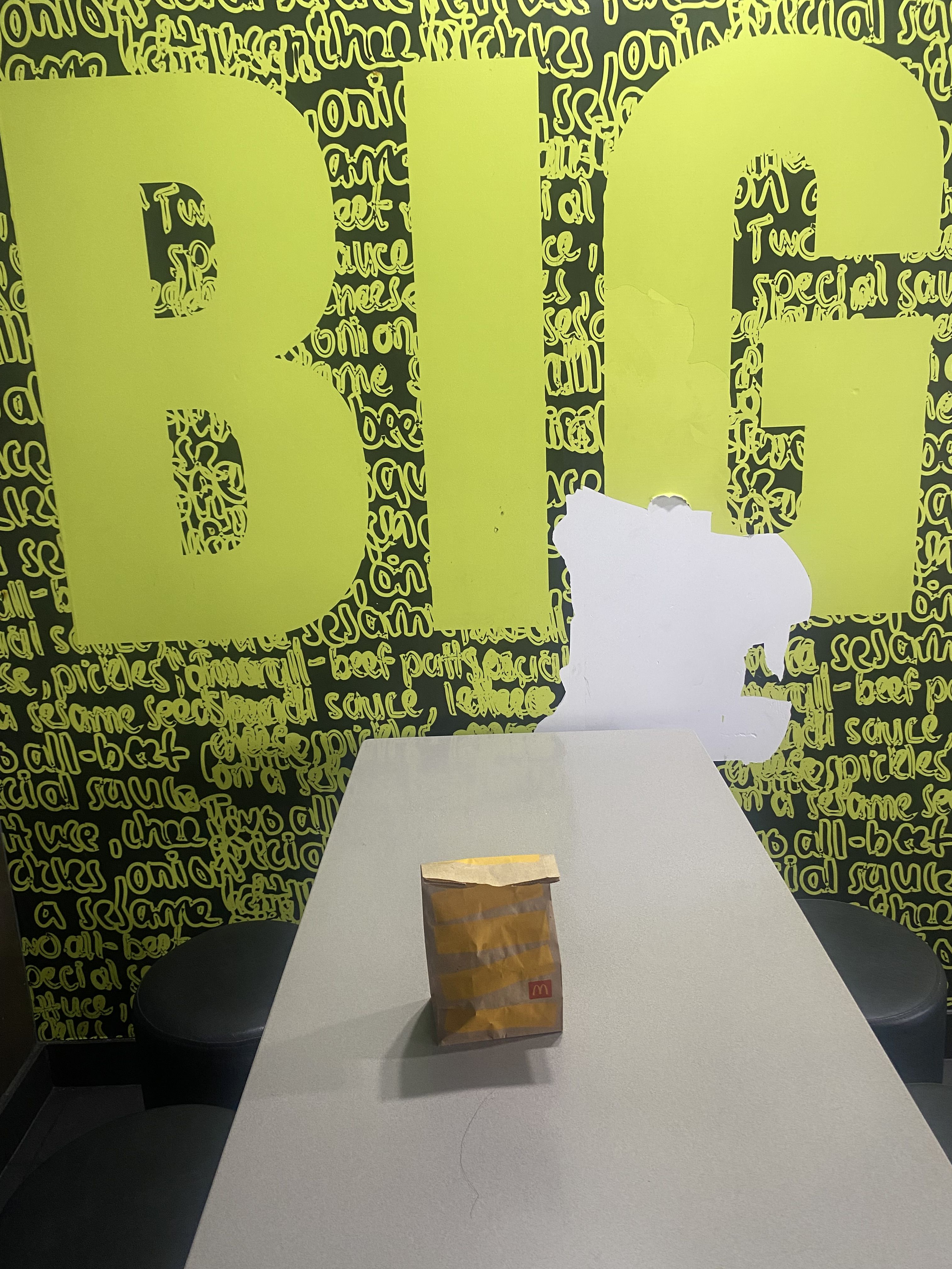 Photo of black and green wall with peeling wallpaper from inside Mcdonalds