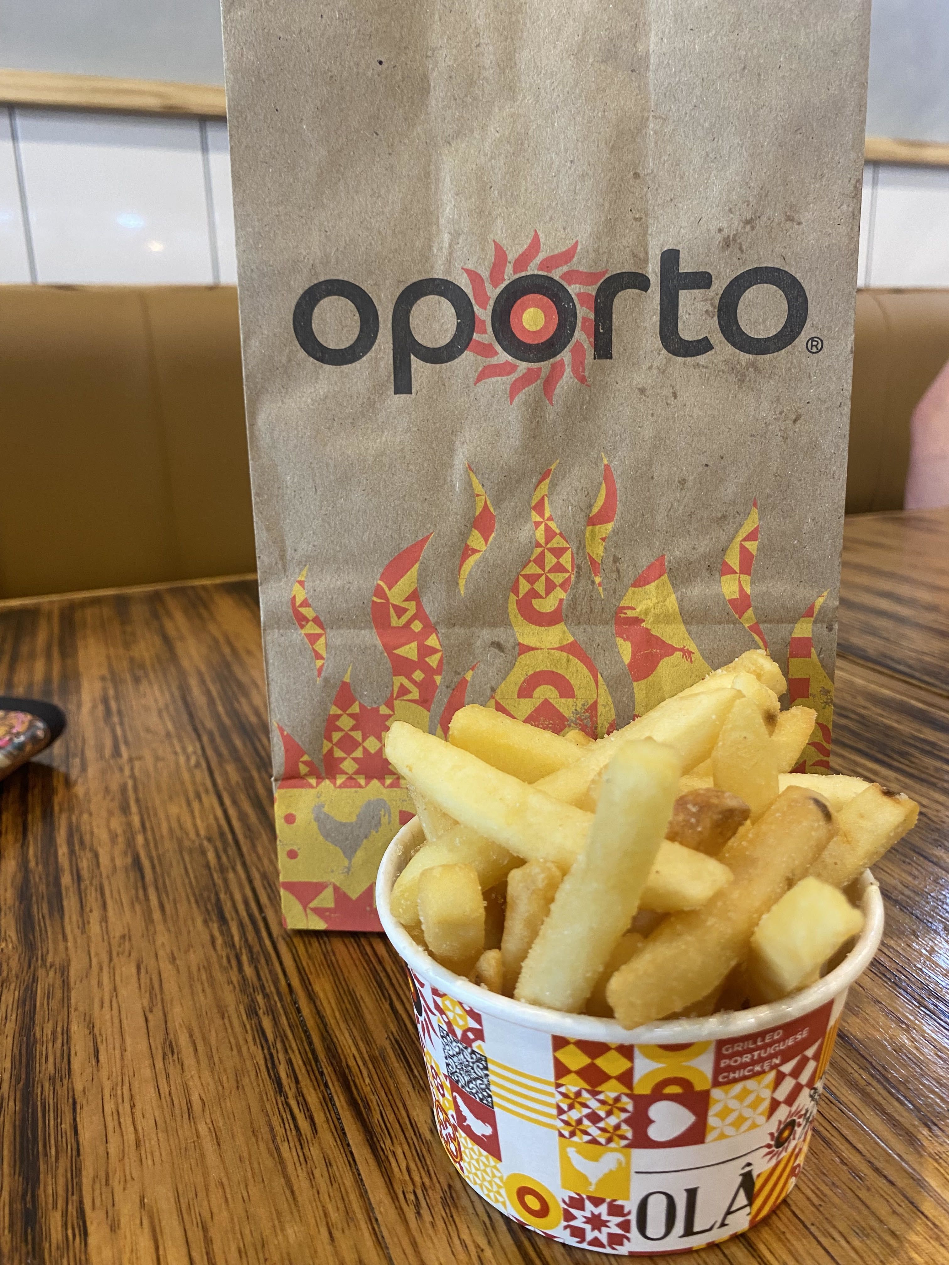 Photo of Oporto chips in small container in front of bag